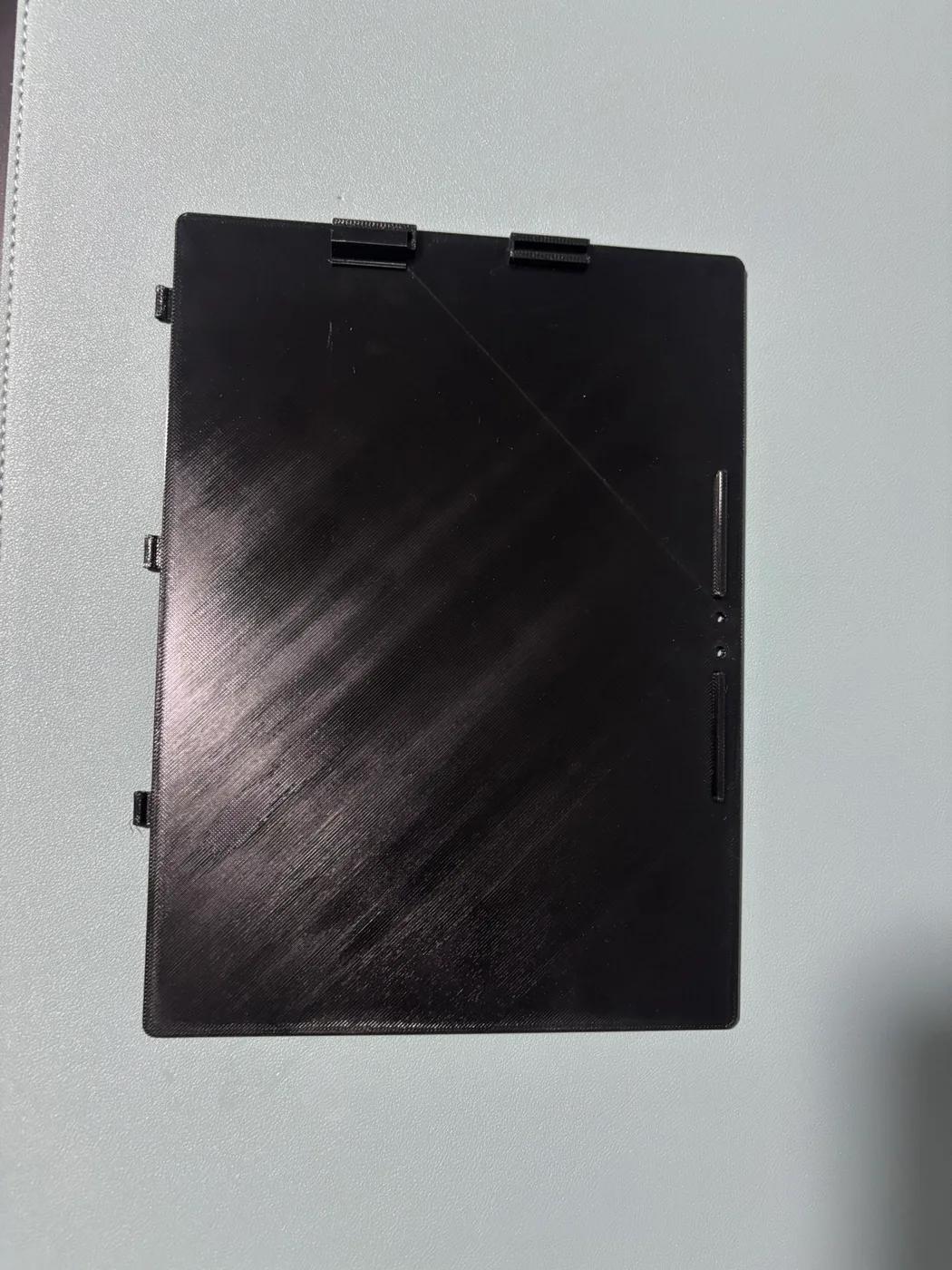 Printed black cover with two accessory mounts and raised side stops.