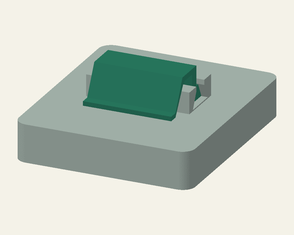 CAD view of a revised green stencil clip installed in its grey socket, showing the arm reaching beyond the socket border.
